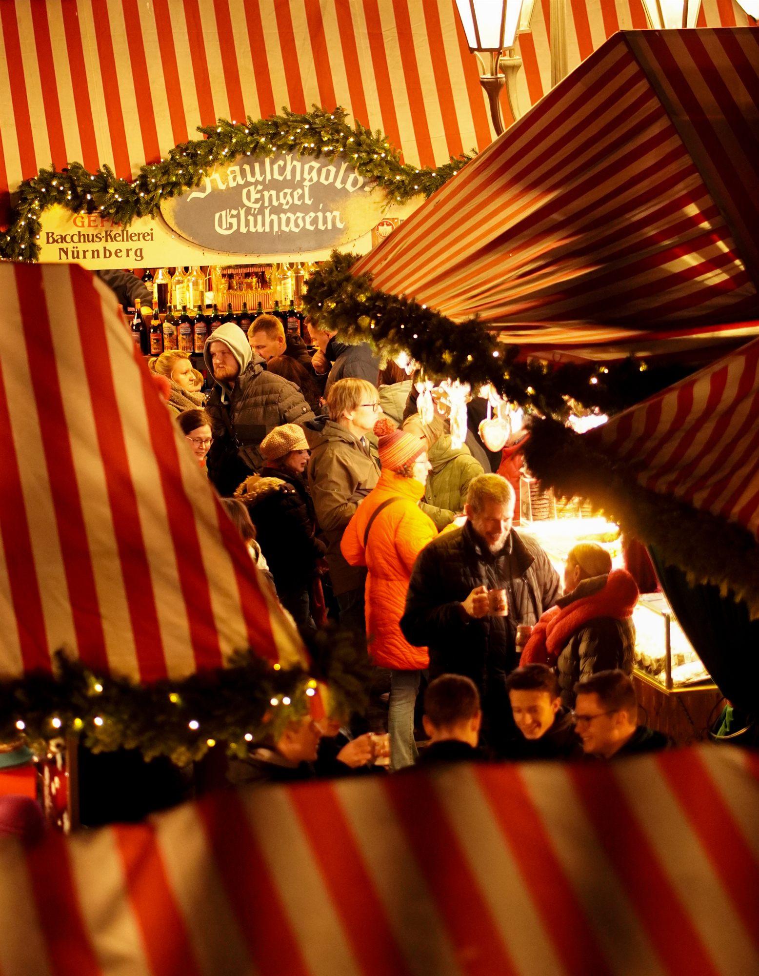 Christmas market street with striped awnings