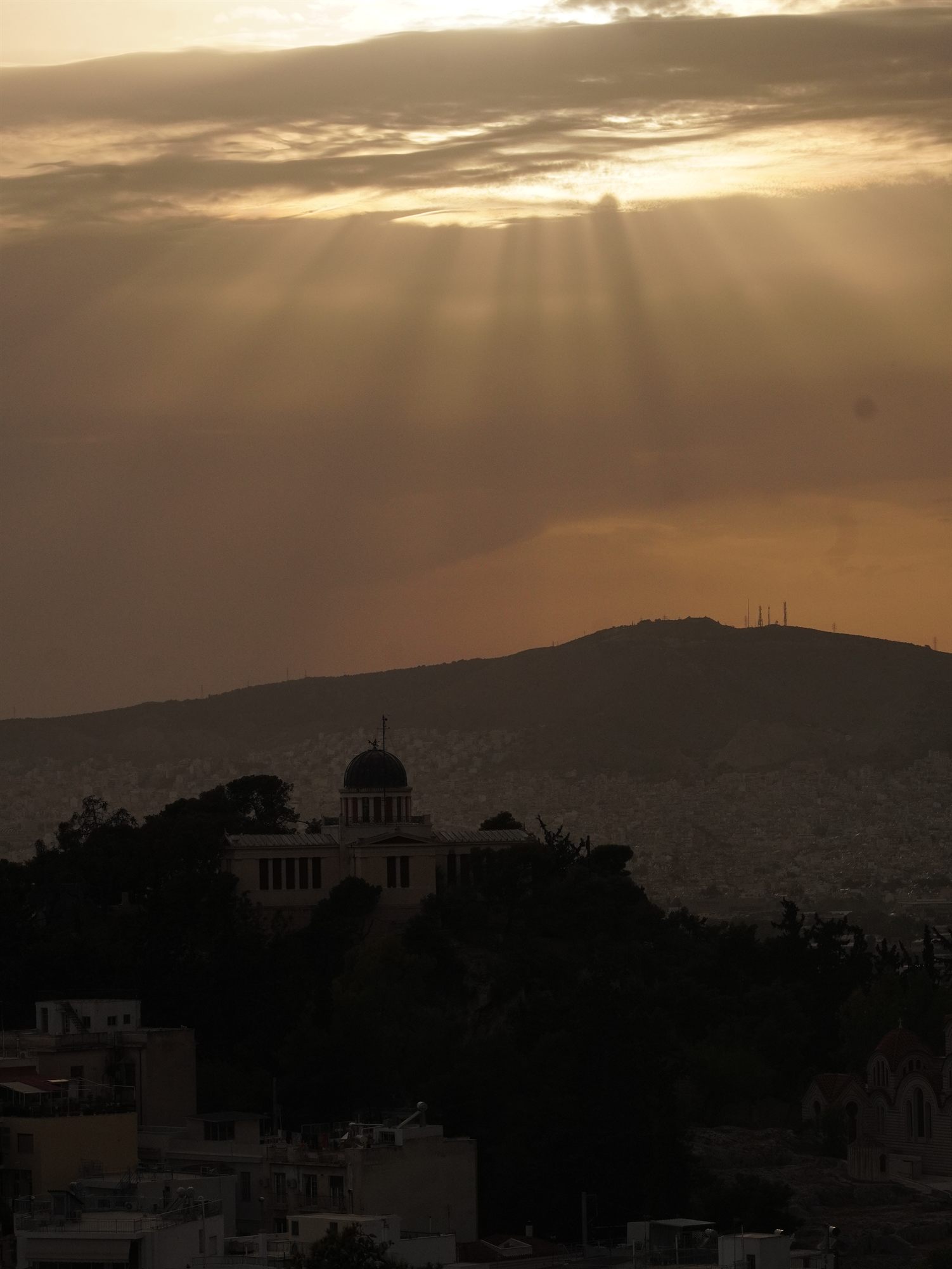 Sunbeams over the hills at dusk